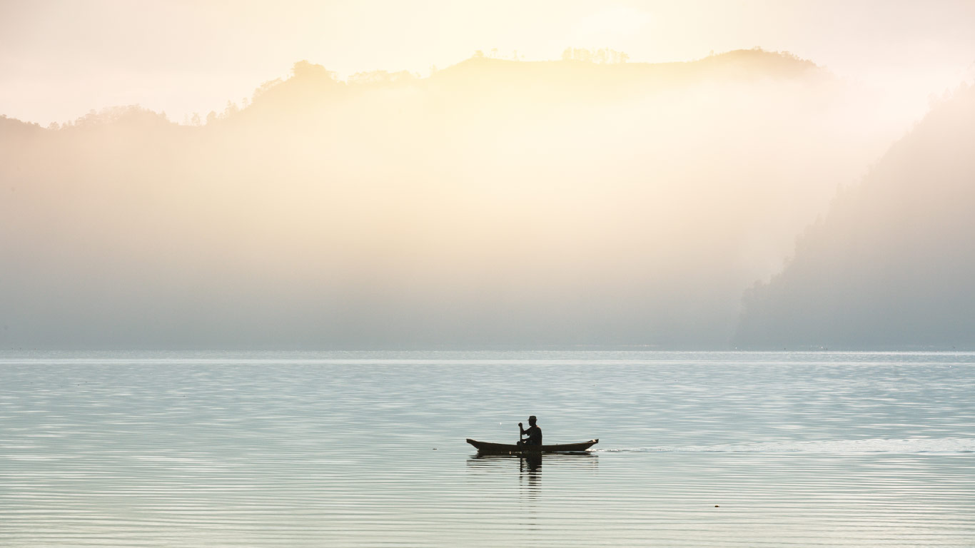 Man on Kayak. Alone in the ocean. Beautiful bright morning