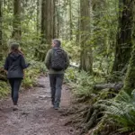 Counsellor and client walking together on a forest trail in North Vancouver